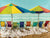 Colorful beach chairs under umbrellas on beach