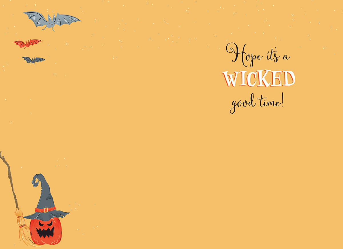 Inside of a Halloween card with a witch hat on a pumpkin, flying bats, and text 'Hope it's a WICKED good time!' on orange background.