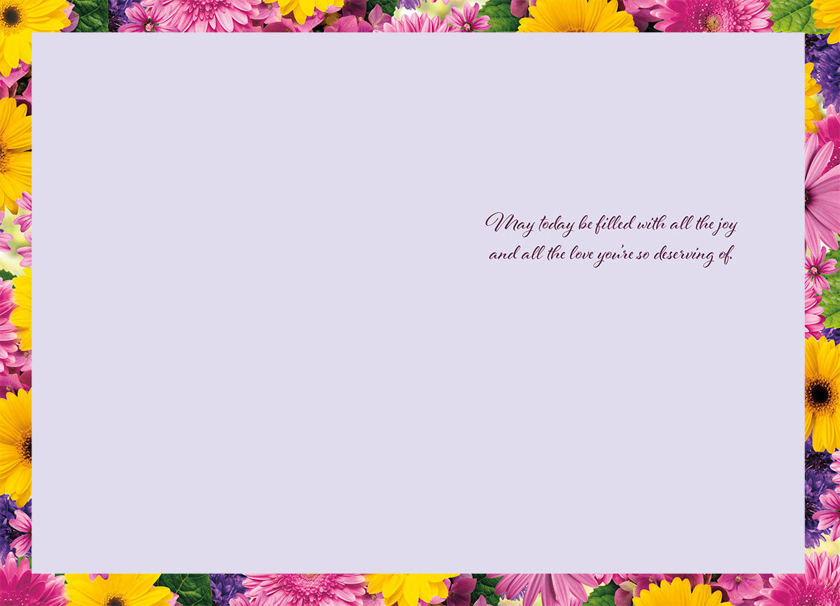 Inside of a Mother's Day card with a heartfelt message, framed by a border of colorful floral patterns.