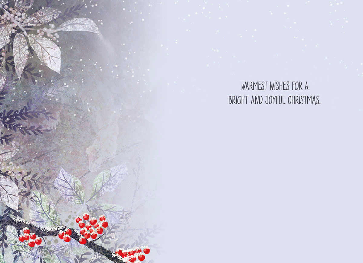 Inside of a festive Christmas card with the message 'WARMEST WISHES FOR A BRIGHT AND JOYFUL CHRISTMAS' and winter foliage.