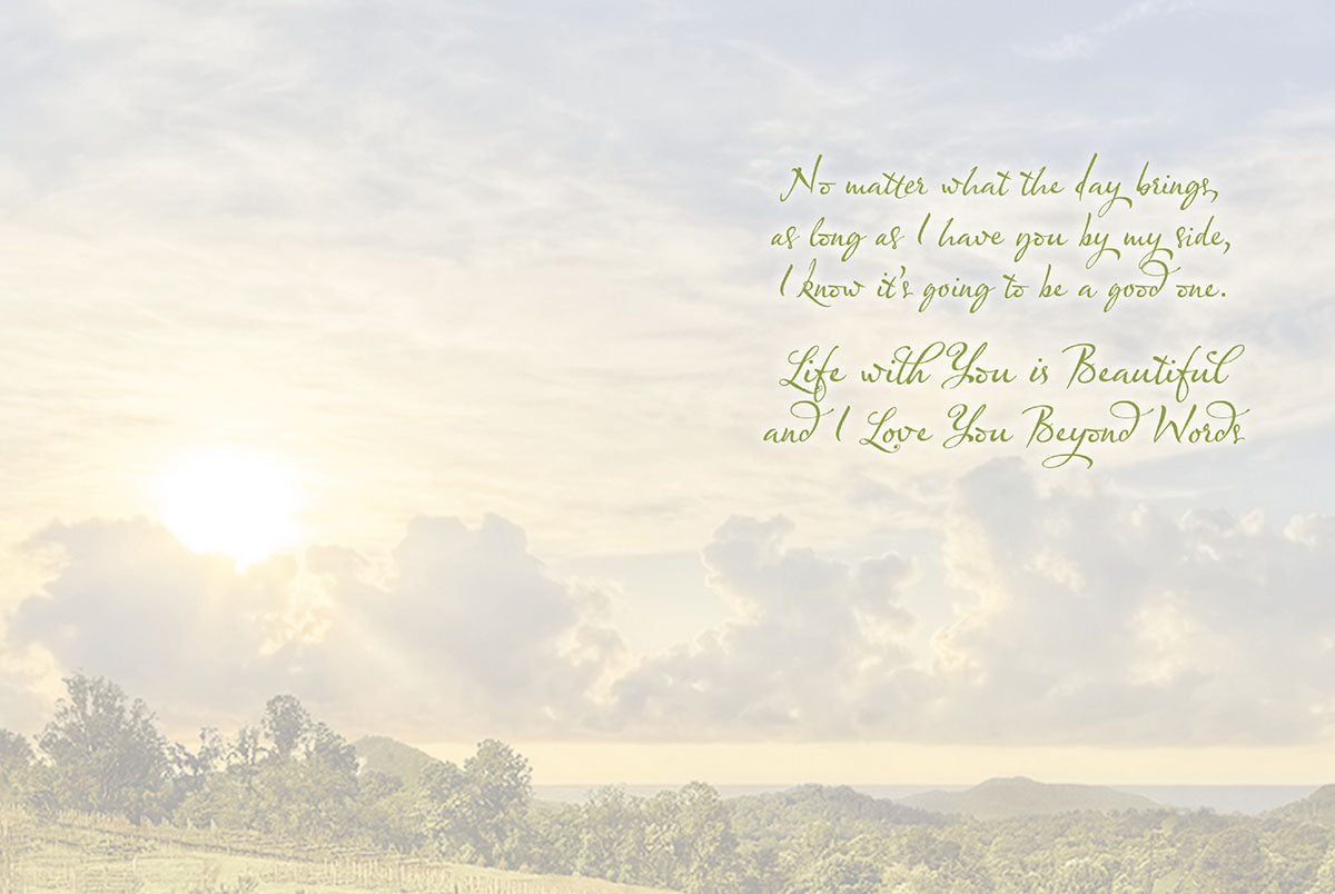 Interior of love card with warm sky and clouds background and touching message about life and enduring love.