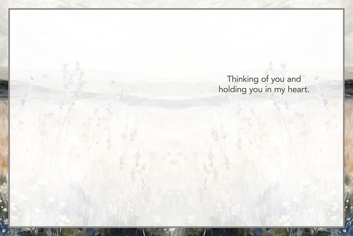 Inside of a sympathy card with matching painterly landscape background, text reads 'Thinking of you and holding you in my heart.'.