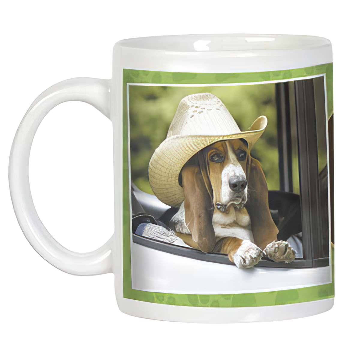 Front view of a white ceramic mug with a cute basset hound in a cowboy hat leaning out of a car window. Green border.