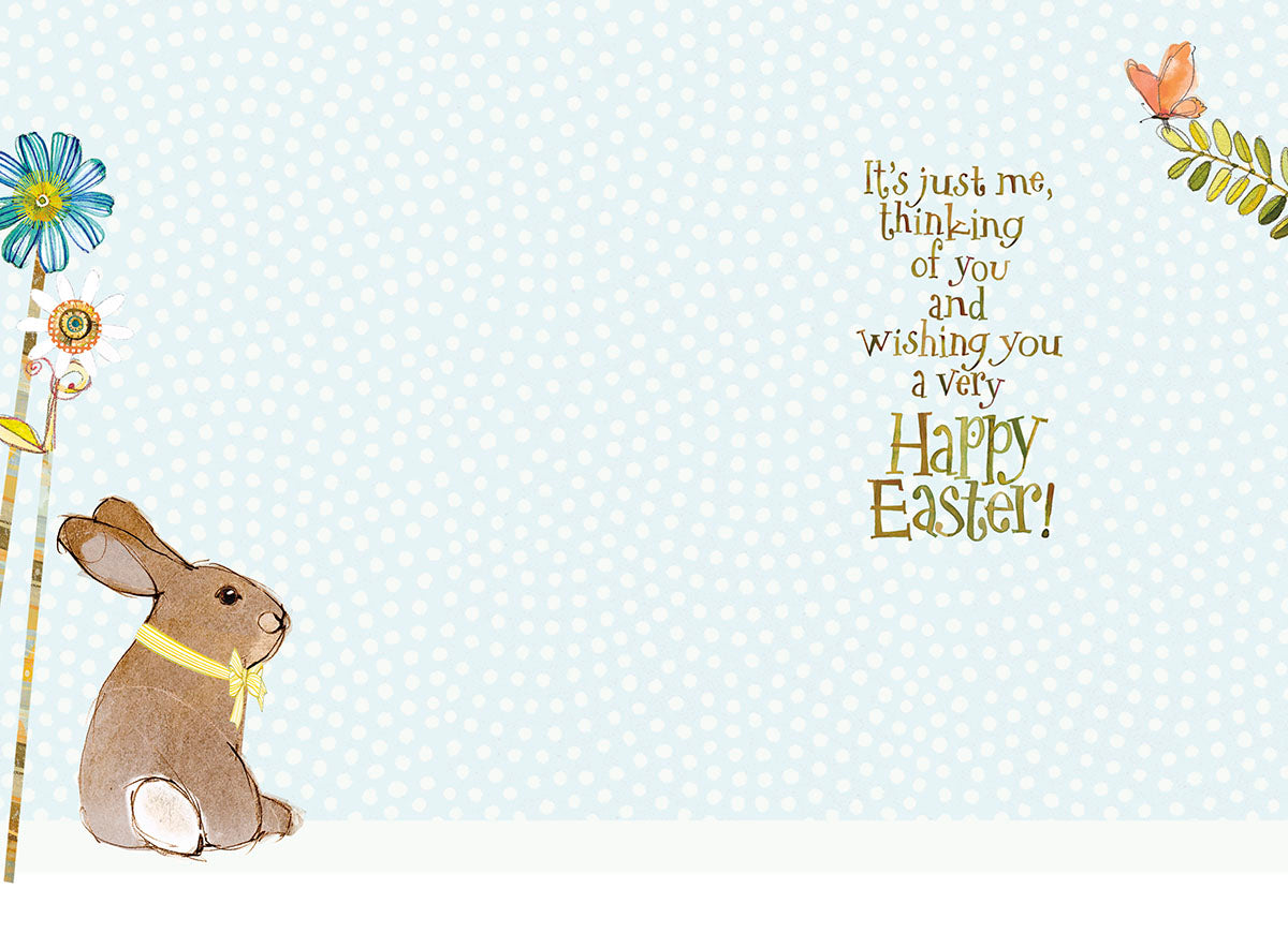 Inside of cute Easter card with sitting bunny and message "Happy Easter!" on a light blue polka dot background.