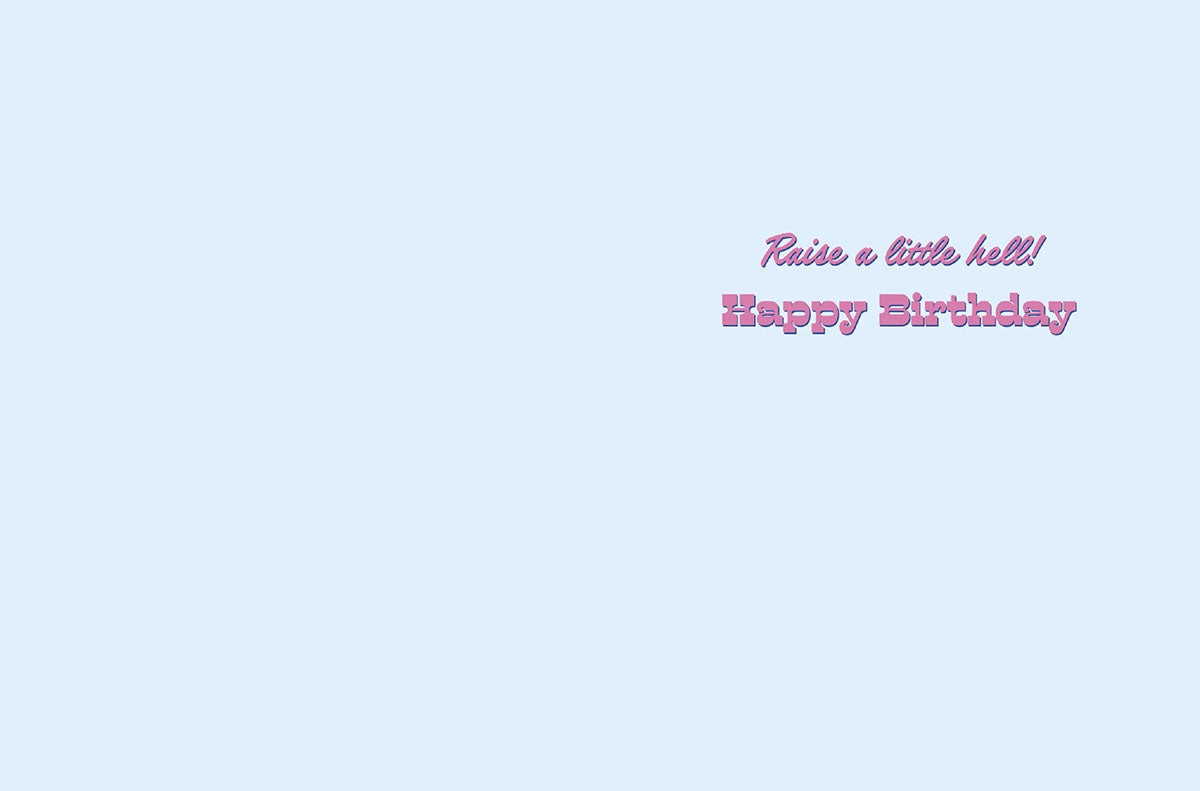 Inside of a light blue birthday card with text 'Raise a little hell! Happy Birthday' in pink and purple fonts.