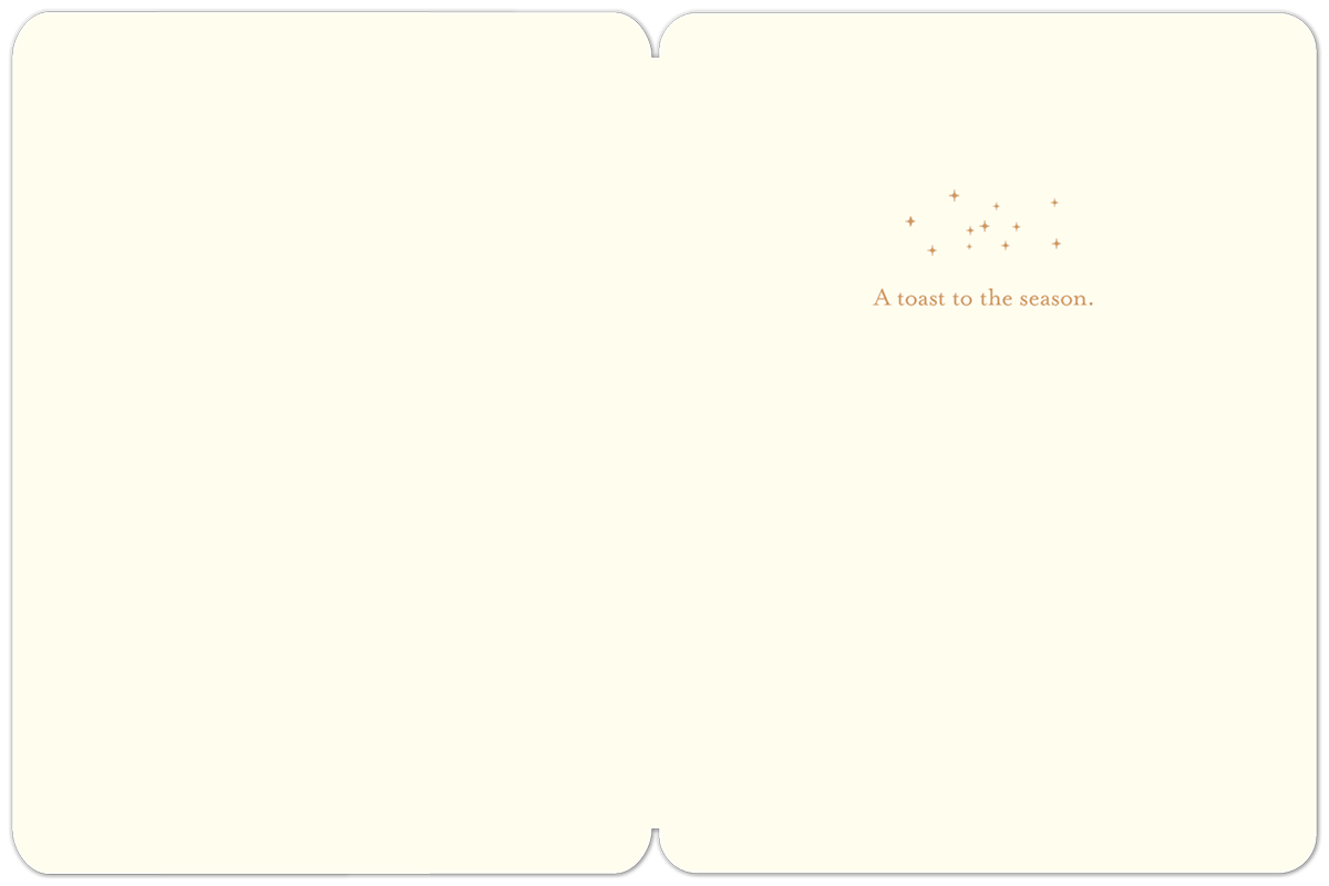 Inside of Halloween card: Cream background, text "A toast to the season." with small golden star accents.
