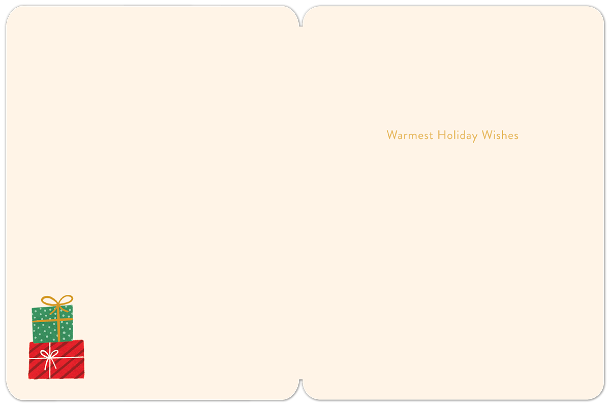 Inside of a cream-colored Christmas card featuring 'Warmest Holiday Wishes' in gold text and a stack of festive gift boxes.