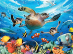 Vibrant underwater scene with sea turtles, clownfish, a shark, dolphin, and colorful coral reefs under sunlit ocean surface.