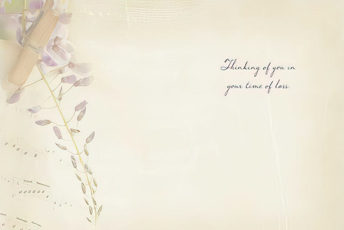 Interior of a sympathy card with 'Thinking of you in your time of loss' message against a faint wisteria background.