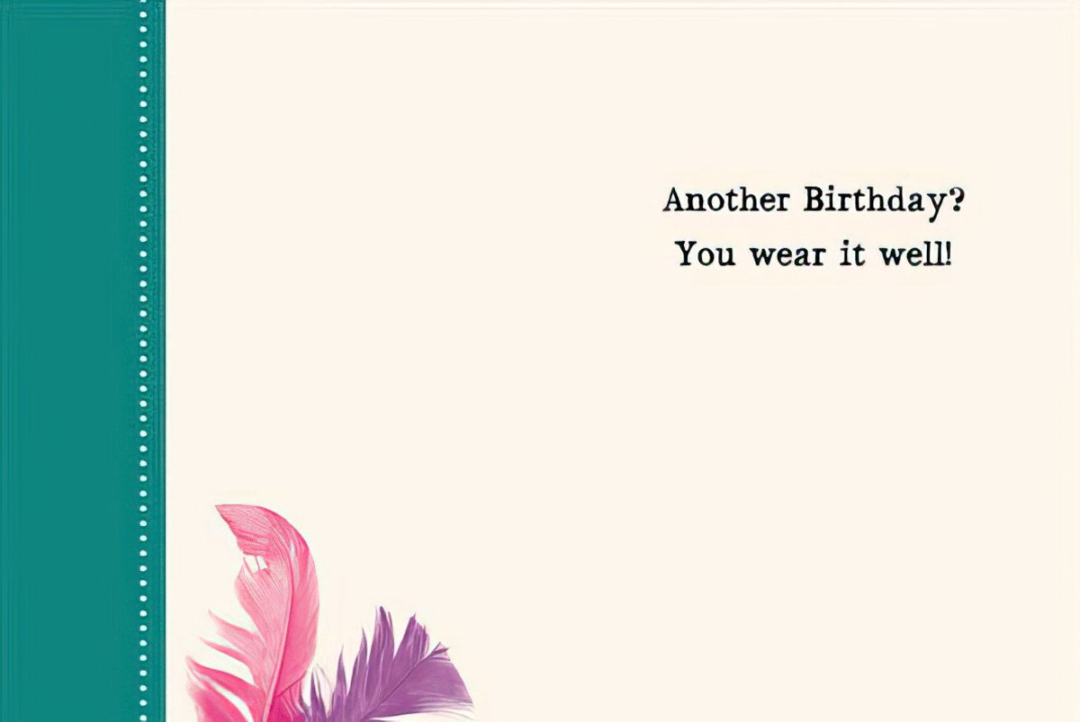 Inside of the squirrel greeting card with feather illustrations and the message 'Another Birthday? You wear it well!'.