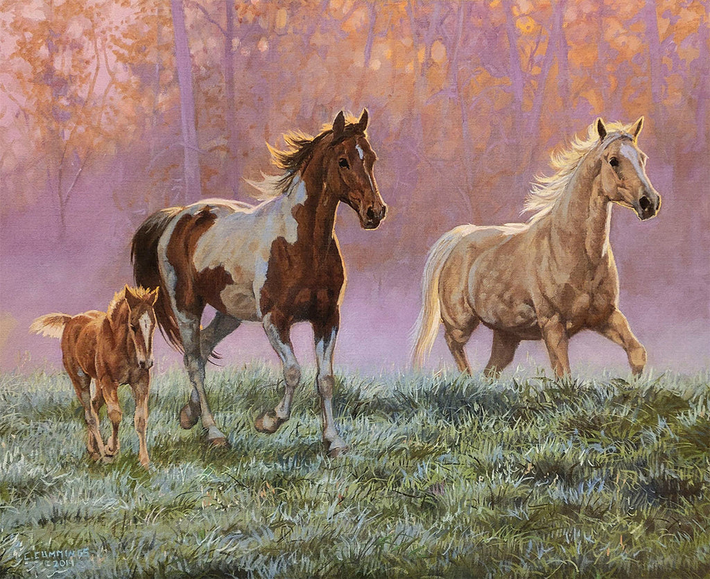 Vibrant painting of three horses, including a foal, a pinto, and a palomino, running through a dewy, grassy field with a warm, glowing forest backdrop.