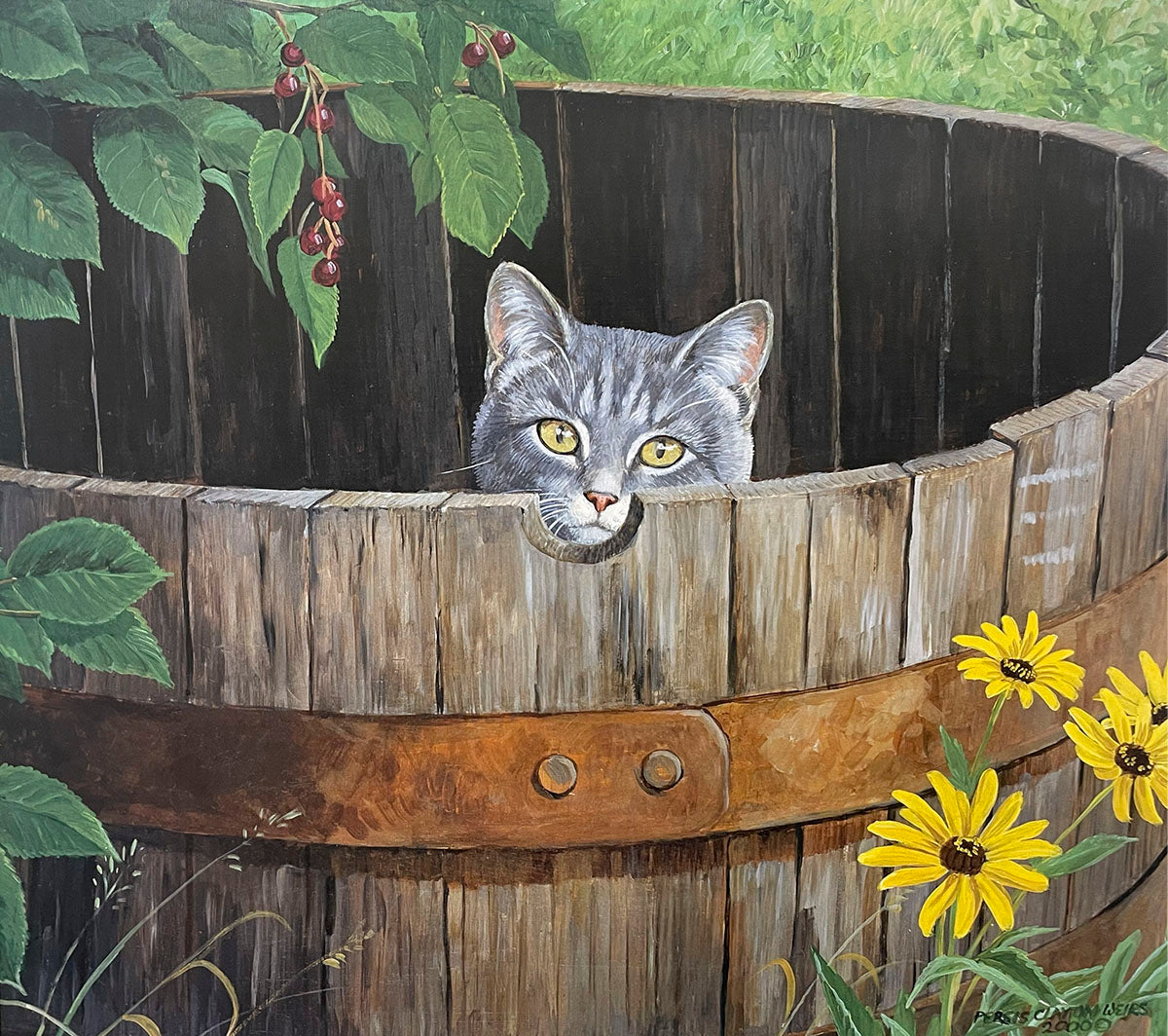 A curious grey tabby kitten with bright yellow eyes peeking out from a small hole in a rustic wooden barrel, surrounded by green leaves and yellow rudbeckia flowers.