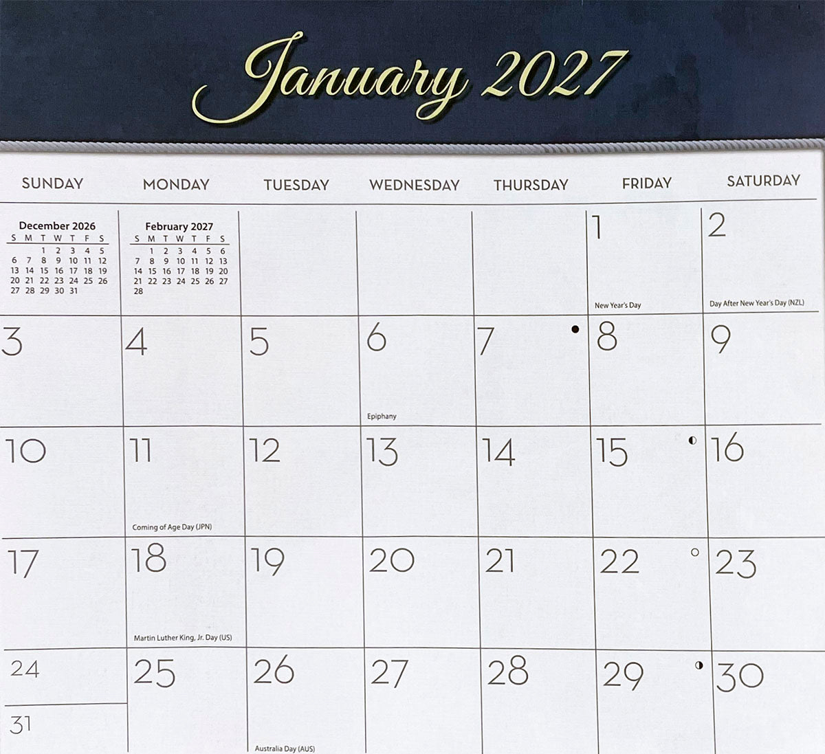A clear close-up image of a 2027 calendar page for January, showing daily grids, New Year's Day, Martin Luther King Jr. Day, and other major holidays with previous and next month mini-calendars.