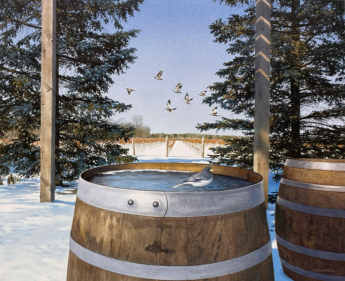 Winter vineyard scene with a bird on a snow-dusted wine barrel, birds flying above, and evergreen trees.