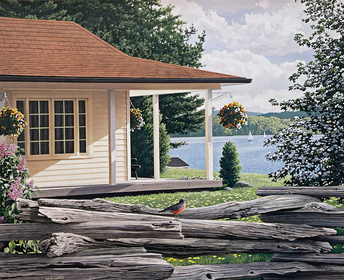 Serene summer lakefront with a charming house, blooming flora, a robin on a log fence, and a sailboat.
