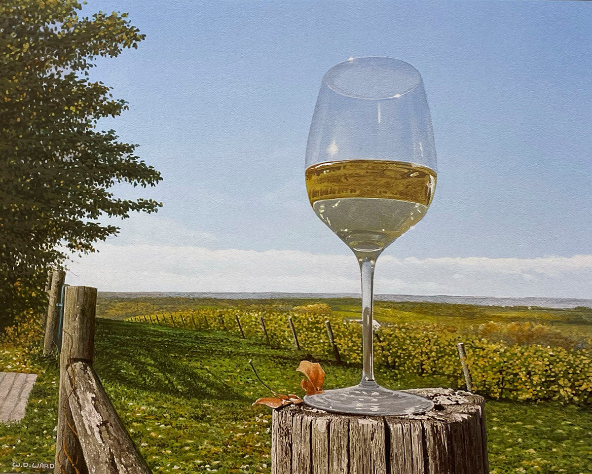 Elegant wine glass on a wooden post, with a golden vineyard stretching into the background under a blue sky.