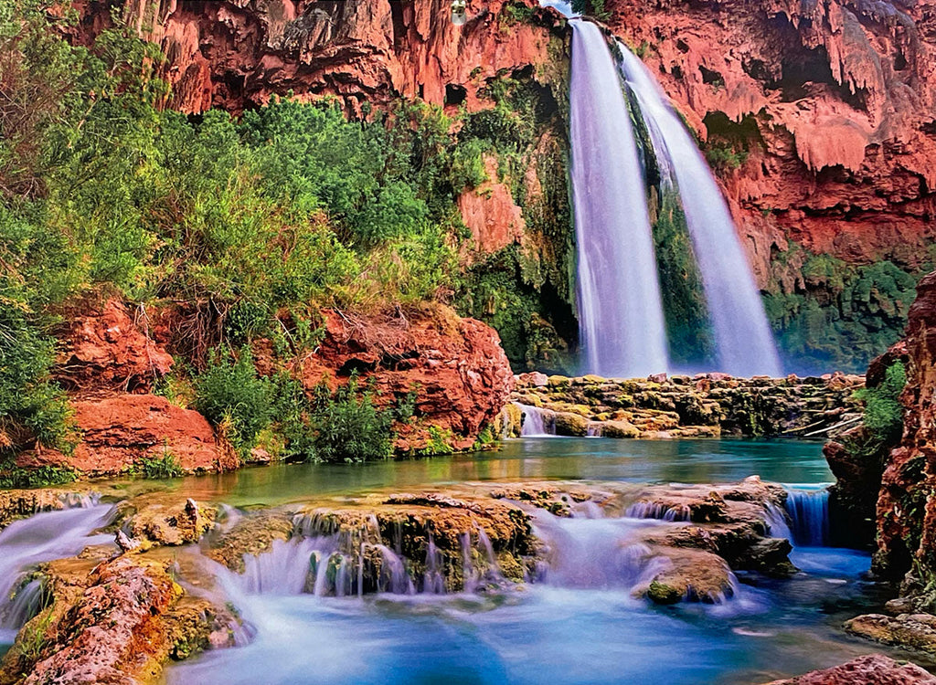 Havasu Falls, Grand Canyon, showing a multi-tiered waterfall cascading into vivid blue-green pools amidst lush foliage and red rock cliffs, a stunning scene for a landscape calendar.