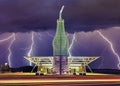Iconic Pop's Soda Ranch with giant soda bottle sculpture under dramatic lightning storm, Route 66 landmark.