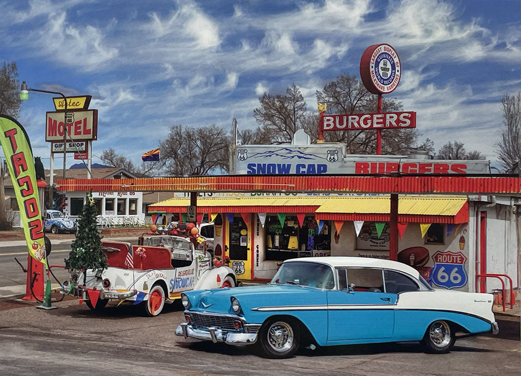 Brightly colored Snow Cap Drive-In on Route 66, featuring a vintage blue and white sedan and other classic vehicles.