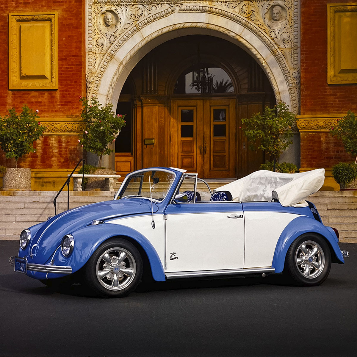 A vibrant blue and white 1968 Volkswagen Beetle convertible with its top down, parked in front of a grand architectural building, radiating timeless charm and open-road freedom.