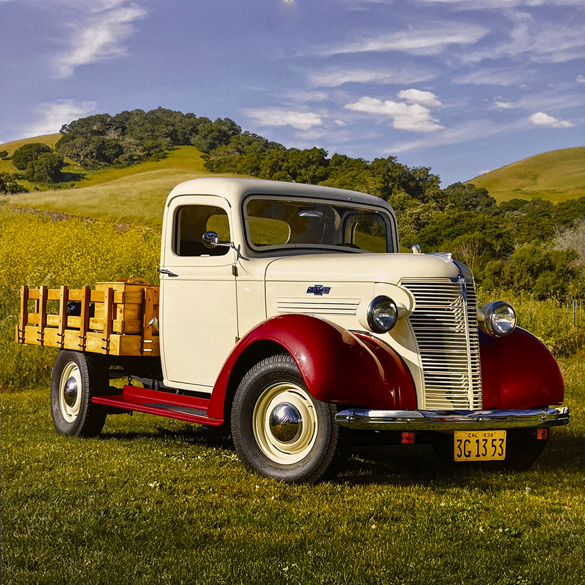 A charming cream and red 1938 Chevrolet Master Sedan Delivery truck with a wooden cargo bed, parked in a sun-drenched green field, capturing the essence of pre-war American automotive design.