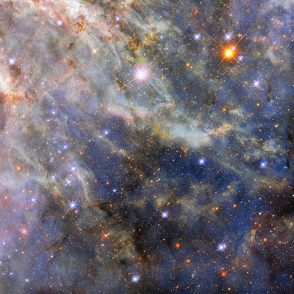 Expansive, turbulent nebula featuring glowing gas, intricate dust lanes, and numerous sparkling stars, creating a celestial tapestry.