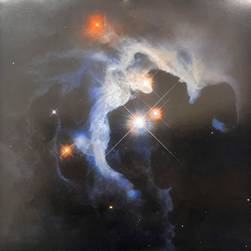 Ethereal nebula with bright young stars illuminating a complex formation of gas and dust clouds, showcasing stellar birth.
