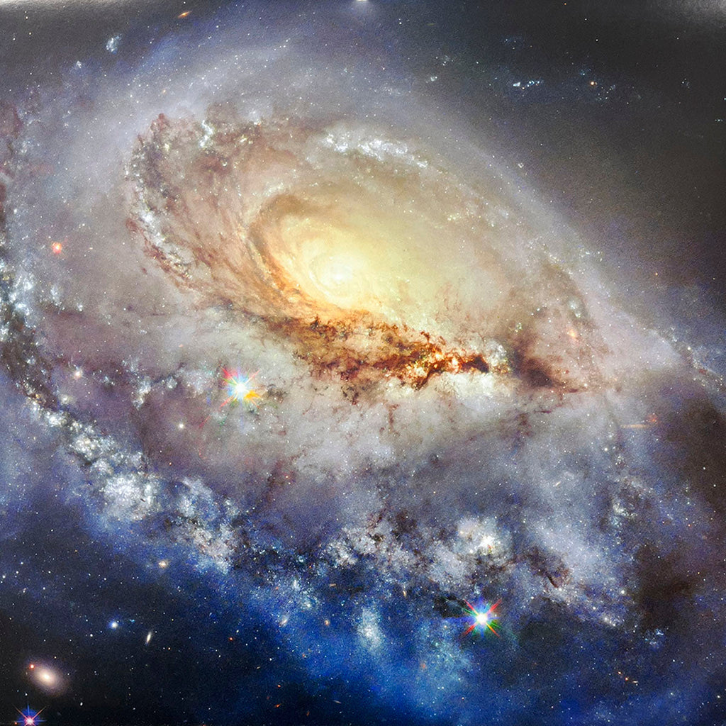 Spectacular spiral galaxy viewed from an angle, highlighting its prominent central bulge and gracefully swirling, star-filled arms.