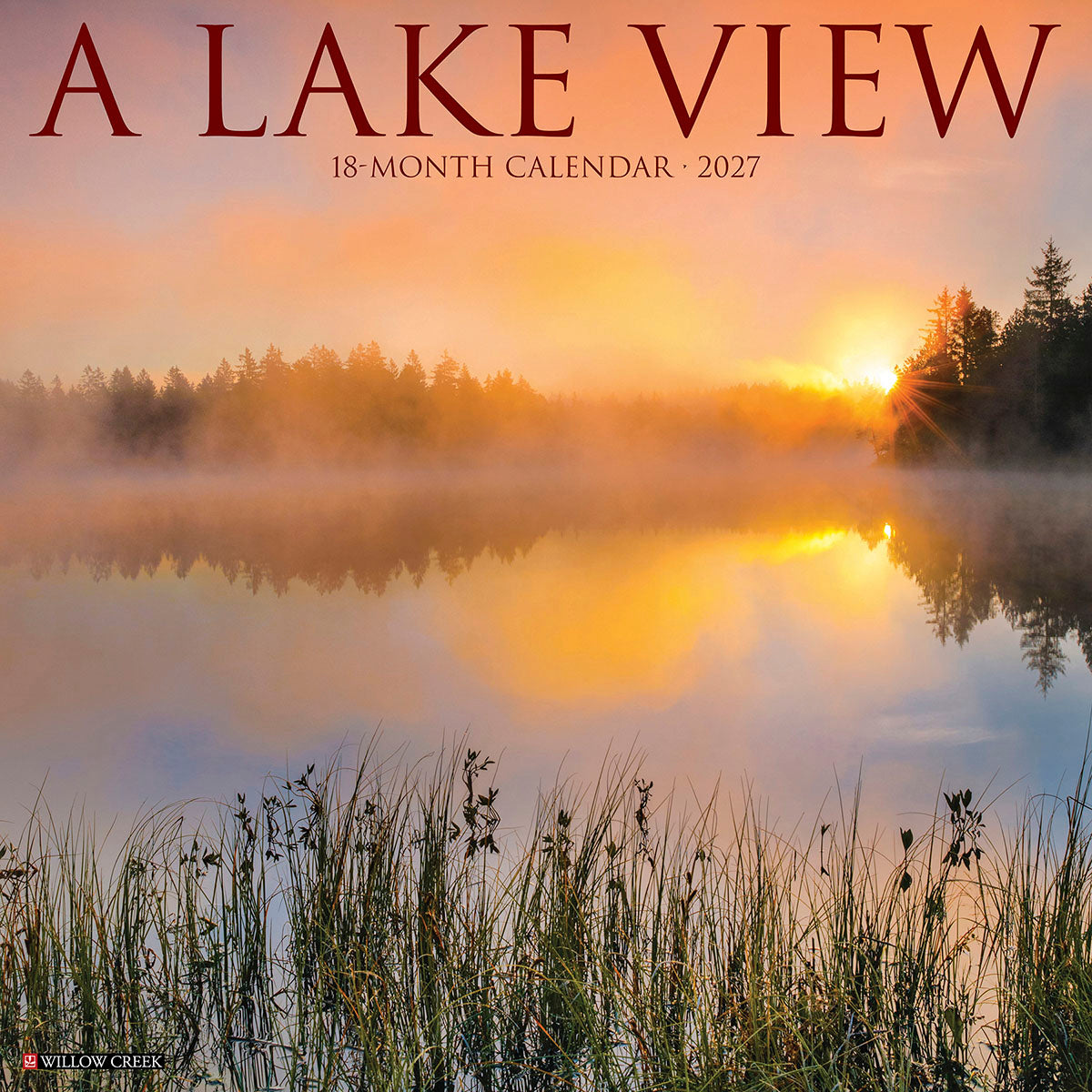 A Lake View 2027 18-Month Wall Calendar featuring a misty sunrise over a serene lake with forest reflection and tall grasses in the foreground.