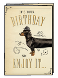 Funny birthday greeting card featuring a charming dachshund dog wearing a bowler hat, surrounded by elegant vintage scrollwork on a cream background, wishing a happy celebration.