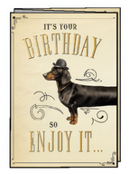 Funny birthday greeting card featuring a charming dachshund dog wearing a bowler hat, surrounded by elegant vintage scrollwork on a cream background, wishing a happy celebration.
