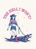 Sassy cowgirl in a pink hat, tied-up denim shirt, cut-off shorts, and red cowboy boots, walking a blue and pink alligator on a leash. Above them, the bold pink text 'THE HELL I WON'T!' arcs across with pink stars on a cream background. This retro-style illustration is perfect for an expressive magnet.