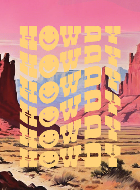 A decorative 'Howdy' magnet with multiple yellow wavy 'Howdy' texts, each 'H' replaced with a smiley face, set against a vibrant desert landscape with red rocks, cacti, and a pink and blue sky.