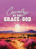Vibrant religious magnet featuring a sunset or sunrise over a desert landscape with mountains, pink-purple foliage, a dirt path, and a starry purple sky. The text 'Country By The Grace Of God' is prominently displayed, making it an inspiring piece of spiritual home decor or a thoughtful gift.
