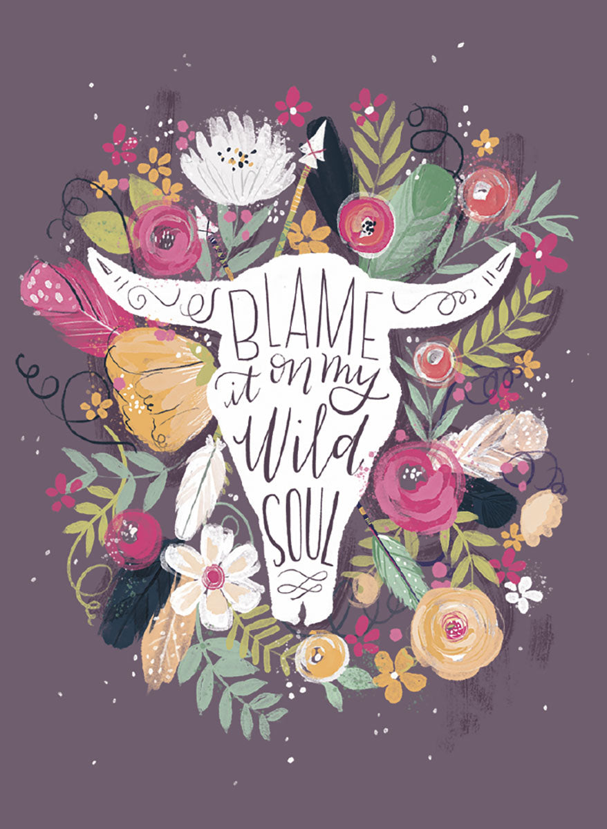 Boho chic fridge magnet featuring a white bull skull silhouette with 'BLAME it on my Wild SOUL' script, encircled by vibrant pink, yellow, and white flowers, green leaves, and delicate feathers on a dark gray-purple background. Ideal for bohemian home decor and free spirit enthusiasts.