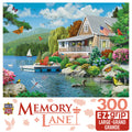 MasterPieces Memory Lane 300-piece EZ-grip jigsaw puzzle depicting a tranquil lakeside cottage with a dock, American flag, sailboat, vibrant garden flowers, lush trees, mountains, and diverse wildlife including butterflies, swan, loon, and cardinal bird, ideal for adults and families seeking relaxation.