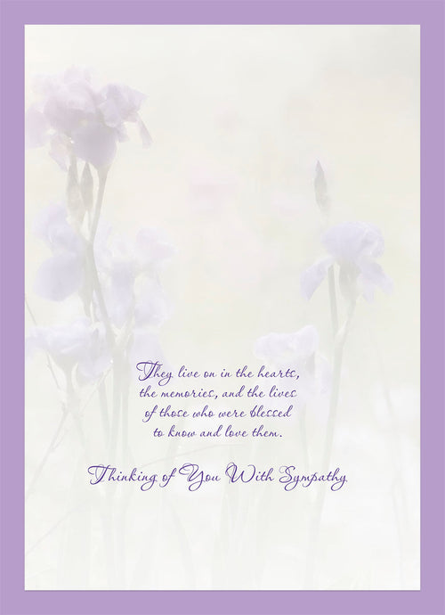 Inside of a thoughtful sympathy card with a soft purple border, displaying a tender message 'They live on in the hearts, the memories, and the lives of those who were blessed to know and love them. Thinking of You With Sympathy.' against a faint floral background.