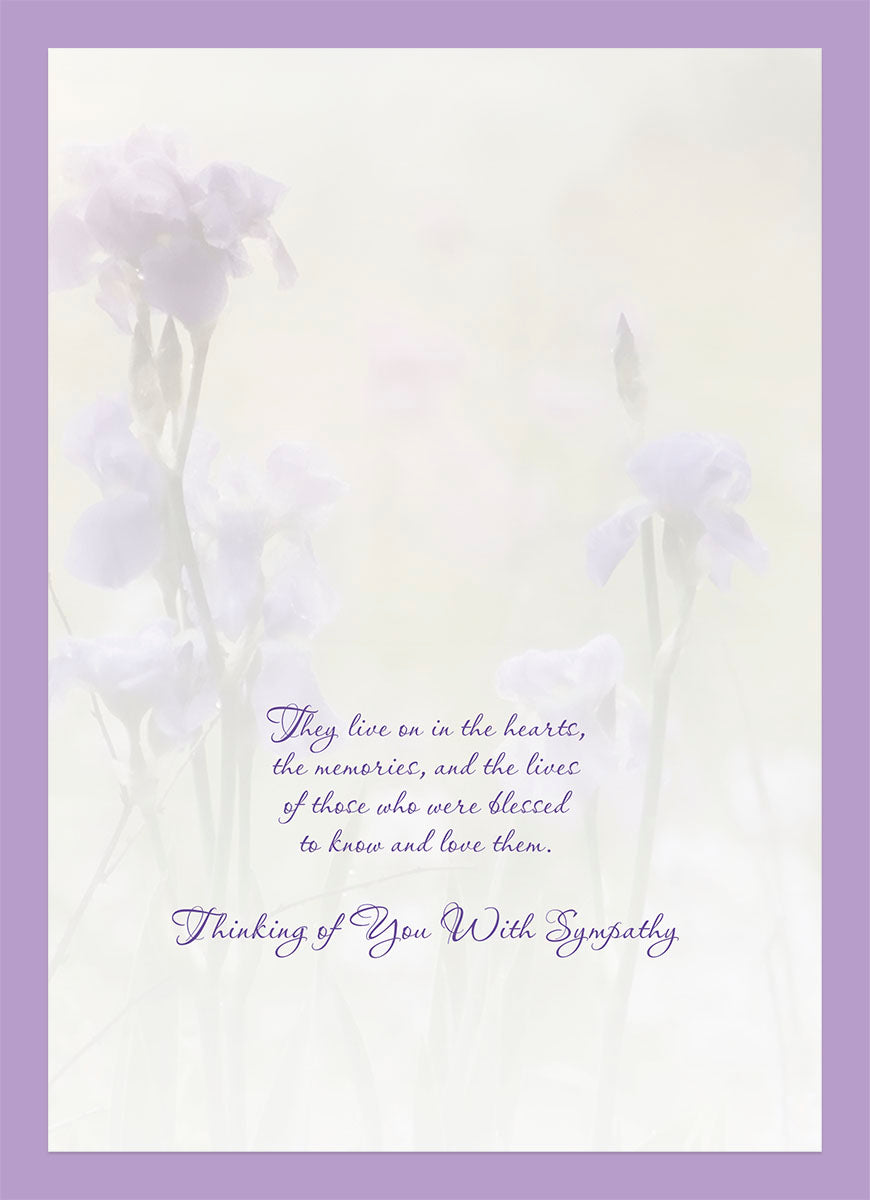 Inside of a thoughtful sympathy card with a soft purple border, displaying a tender message 'They live on in the hearts, the memories, and the lives of those who were blessed to know and love them. Thinking of You With Sympathy.' against a faint floral background.