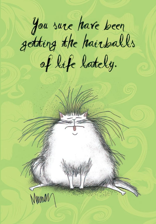 Front of a green greeting card with a fluffy, messy white cat sticking its tongue out, and the text 'You sure have been getting the hairballs of life lately.'