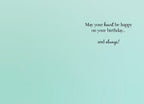 Inside of a serene teal-colored birthday card with elegant black script reading 'May your heart be happy on your birthday... and always!' conveying a warm and lasting wish for happiness.