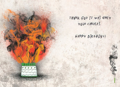 Inside of a funny birthday card showing an illustrated cake with many glowing, burning candles, emitting dramatic smoke and flames. Text reads "THANK GOD IT WAS ONLY YOUR CANDLES. HAPPY BIRTHDAY!" The background is a textured, light-colored wall.