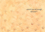 Inside of a humorous greeting card, light orange background with subtle paw print patterns, featuring the witty message '...weren't you old enough last year?' in brown script font.