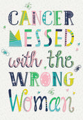 Front of a vibrant greeting card for women with cancer, featuring colorful, patterned block letters spelling 'CANCER MESSED with the WRONG WOMAN' amidst small butterflies and hearts. Perfect for a strong female friend fighting cancer.