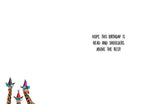 Inside of a greeting card with a playful message 'HOPE THIS BIRTHDAY IS HEAD AND SHOULDERS ABOVE THE REST!' next to a small illustration of giraffes.