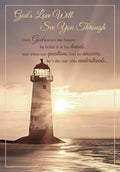 Religious greeting card featuring a majestic lighthouse on a rocky shore at sunrise or sunset with golden light, and the spiritual message 'God's Love Will See You Through' for hope and comfort.