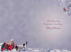 Interior of a charming holiday greeting card displaying a golden retriever puppy in a red gift box and a terrier mix dog in a snow scene, with the heartwarming printed message: 'Hope Santa knows how good you've been this year Merry Christmas'.