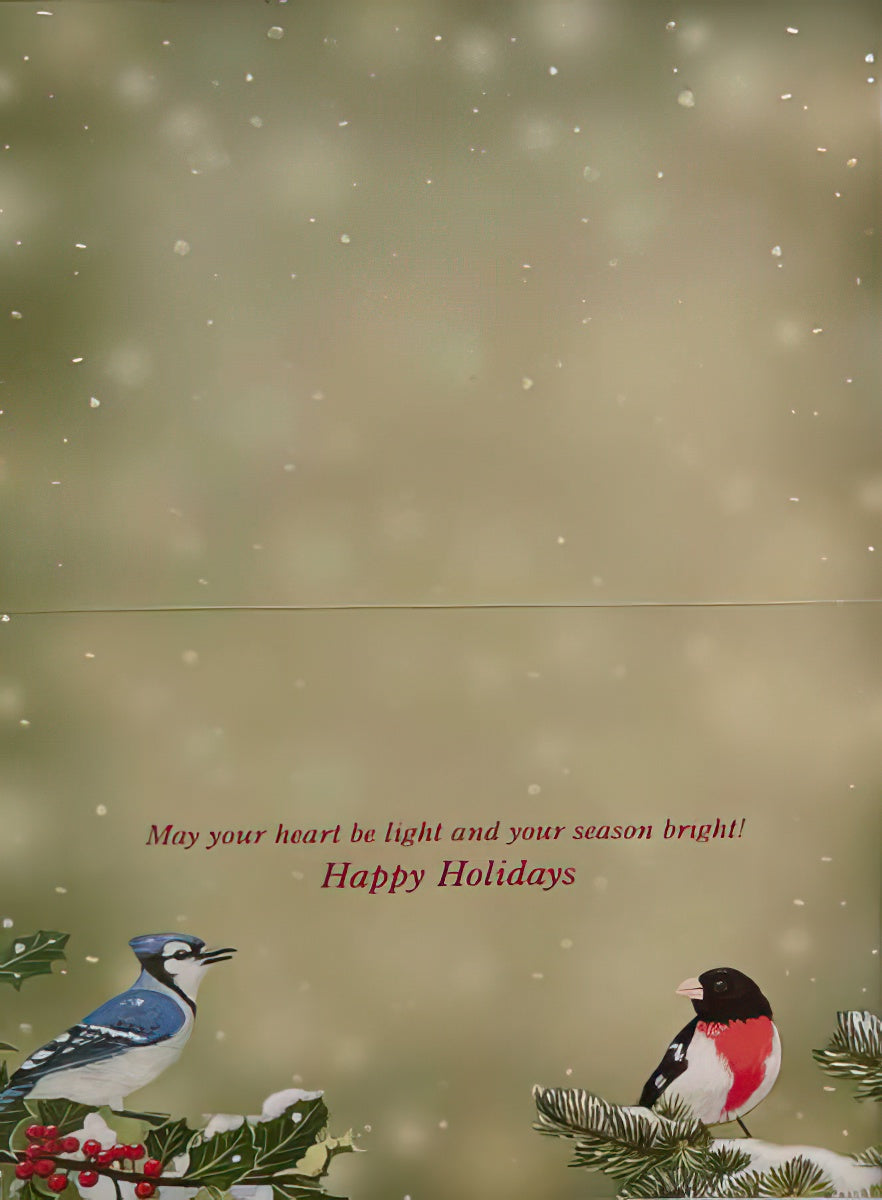 Inside view of a joyful season's greetings card displaying a blue jay and rosy finch on snowy holly, with a heartwarming holiday message in elegant red script.