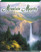 The front cover of the 'Mountain Majesty Note Cards by Charles H. Pabst' box set, displaying a majestic waterfall cascading down a mountain face into a river, surrounded by pine trees and a vibrant, sunlit landscape. The title 'Mountain Majesty' is prominently featured in green script.