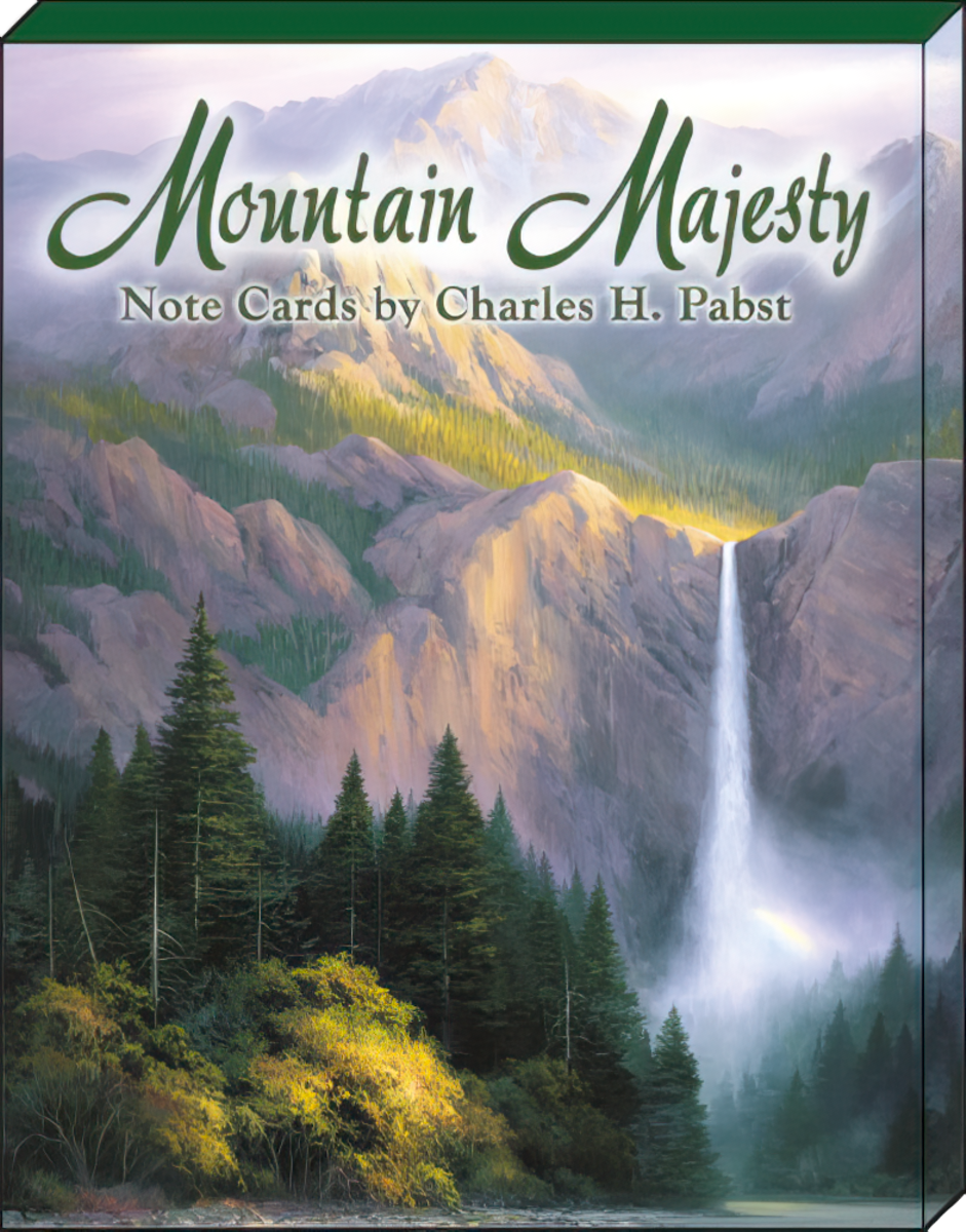 The front cover of the 'Mountain Majesty Note Cards by Charles H. Pabst' box set, displaying a majestic waterfall cascading down a mountain face into a river, surrounded by pine trees and a vibrant, sunlit landscape. The title 'Mountain Majesty' is prominently featured in green script.