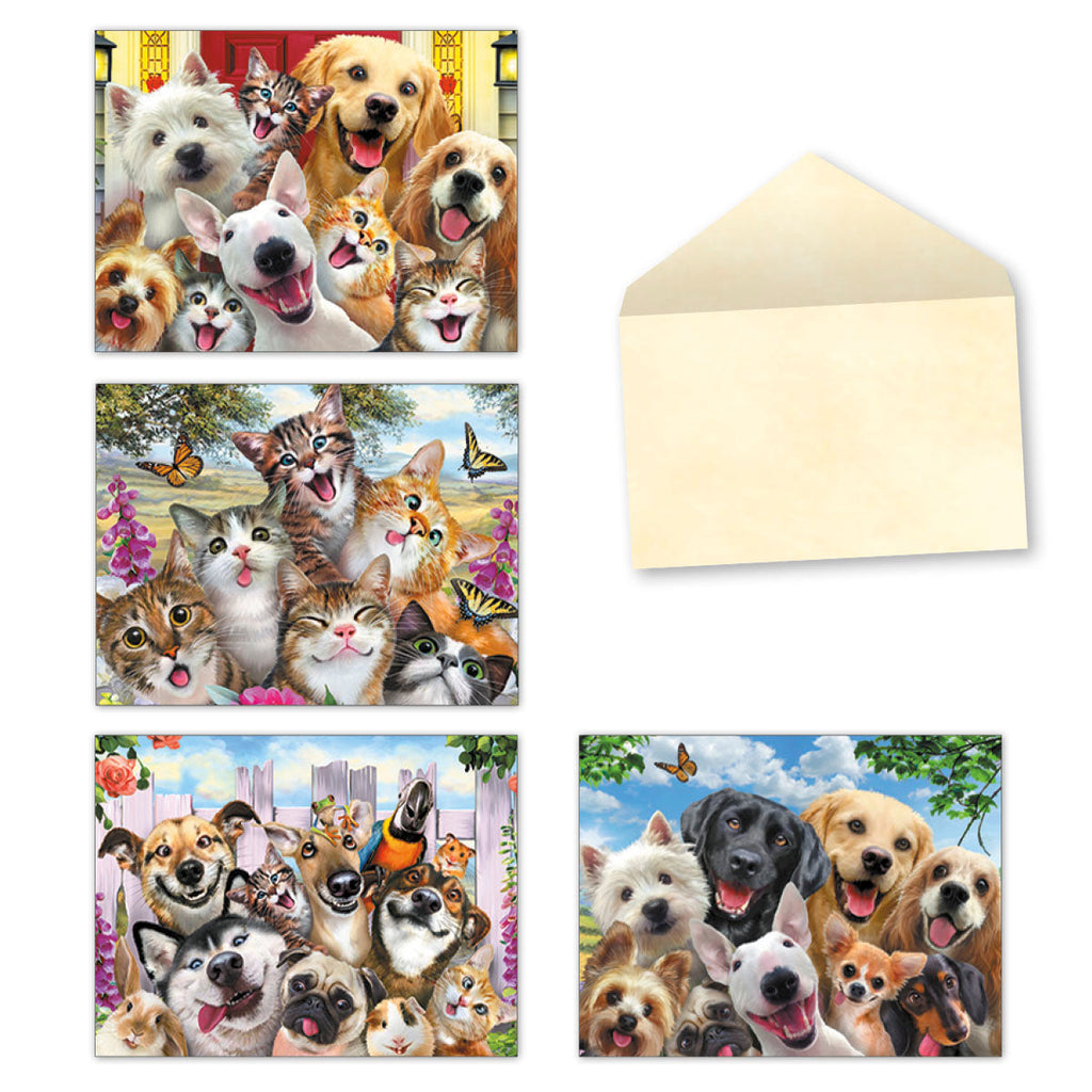 Assortment of four greeting cards featuring groups of cheerful, smiling dogs and cats in 'selfie' style poses, next to an open beige envelope.